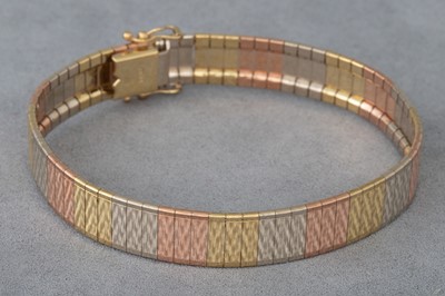 Lot 174 - A 9CT TRI COLOUR GOLD BRACELET, engine turned...