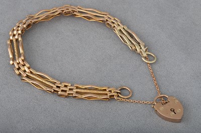 Lot 180 - A 9CT GOLD GATE BRACELET, engraved decoration...