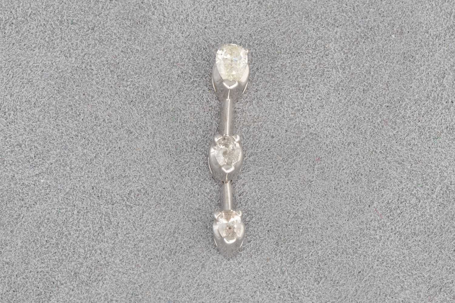 Lot 55 - A DIAMOND PENDANT, set with three pear shaped...
