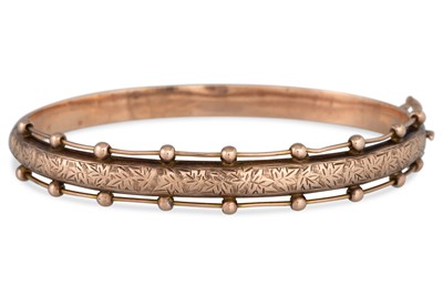 Lot 4 - AN ANTIQUE 9CT GOLD BANGLE, engraved...