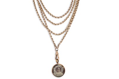 Lot 5 - A VINTAGE GOLD MUFF CHAIN, suspending a photo...