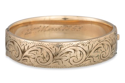 Lot 7 - A METAL CORE BANGLE, engraved decoration