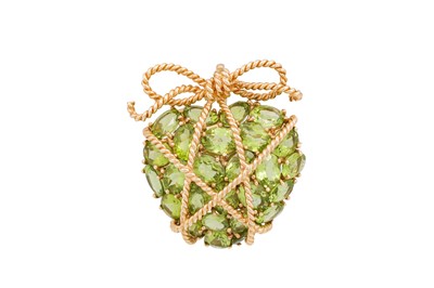 Lot 266 - A PERIDOT BROOCH, modelled as a heart wrapped...