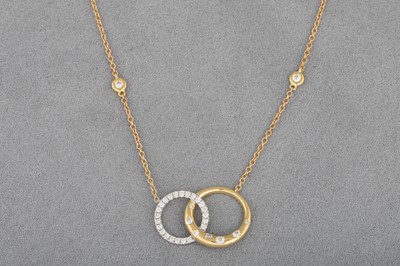 Lot 14 - A DIAMOND SET PENDANT, modelled as two...