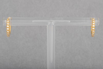 Lot 23 - A PAIR OF DIAMOND SET HOOP EARRINGS, "huggie"...