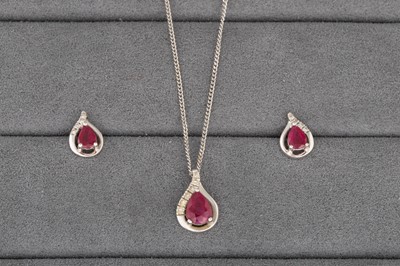 Lot 106 - A RUBY AND DIAMOND PENDANT, the pear shaped...