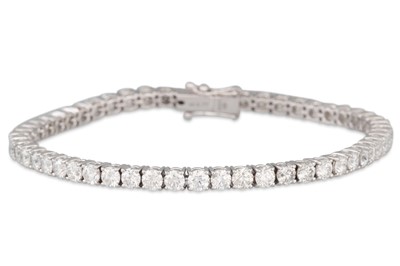 Lot 82 - A DIAMOND LINE BRACELET, the brilliant cut...