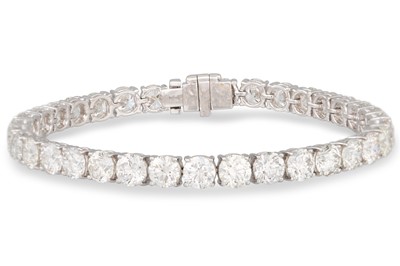 Lot 84 - A DIAMOND LINE BRACELET, the brilliant cut...