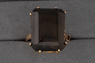 Lot 86 - A SMOKEY QUARTZ RING, mounted in 9ct gold,...