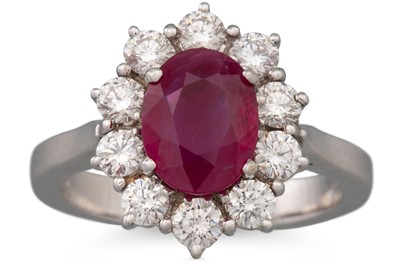 Lot 264 - A RUBY AND DIAMOND CLUSTER RING, the central...