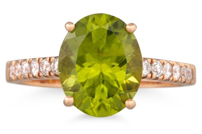 Lot 117 - A PERIDOT AND DIAMOND RING, the oval peridot...