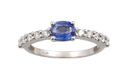 Lot 385 - A SAPPHIRE AND DIAMOND RING, the oval sapphire...