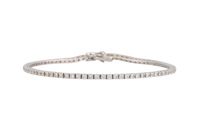 Lot 386 - A DIAMOND LINE BRACELET, the brilliant cut...