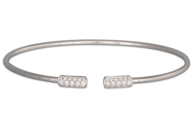 Lot 218 - A DIAMOND SET BANGLE, open style, each end...