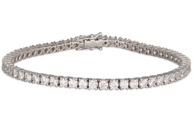 Lot 251 - A DIAMOND LINE BRACELET, the brilliant cut...