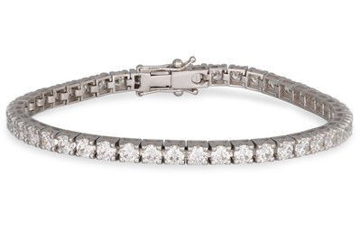 Lot 252 - A DIAMOND LINE BRACELET, the brilliant cut...