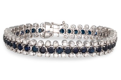 Lot 253 - A DIAMOND AND SAPPHIRE LINE BRACELET, the...