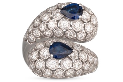 Lot 254 - A DIAMOND AND SAPPHIRE BOMBÉ CROSSOVER RING,...