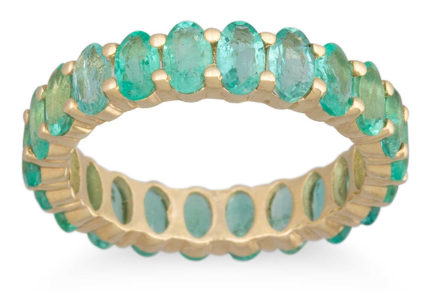 Lot 150 - A FULL BANDED EMERALD ETERNITY RING, mounted