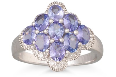 Lot 52 - A DIAMOND AND TANZANITE CLUSTER RING, nine...