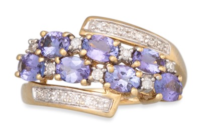 Lot 76 - A DIAMOND AND TANZANITE CLUSTER RING, of cross-...