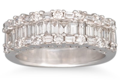 Lot 301 - A THREE ROWED DIAMOND RING, set with baguette...