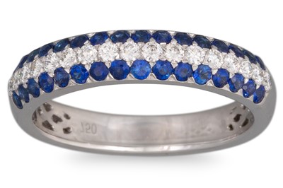 Lot 229 - A DIAMOND AND SAPPHIRE PAVÉ SET BAND, mounted...