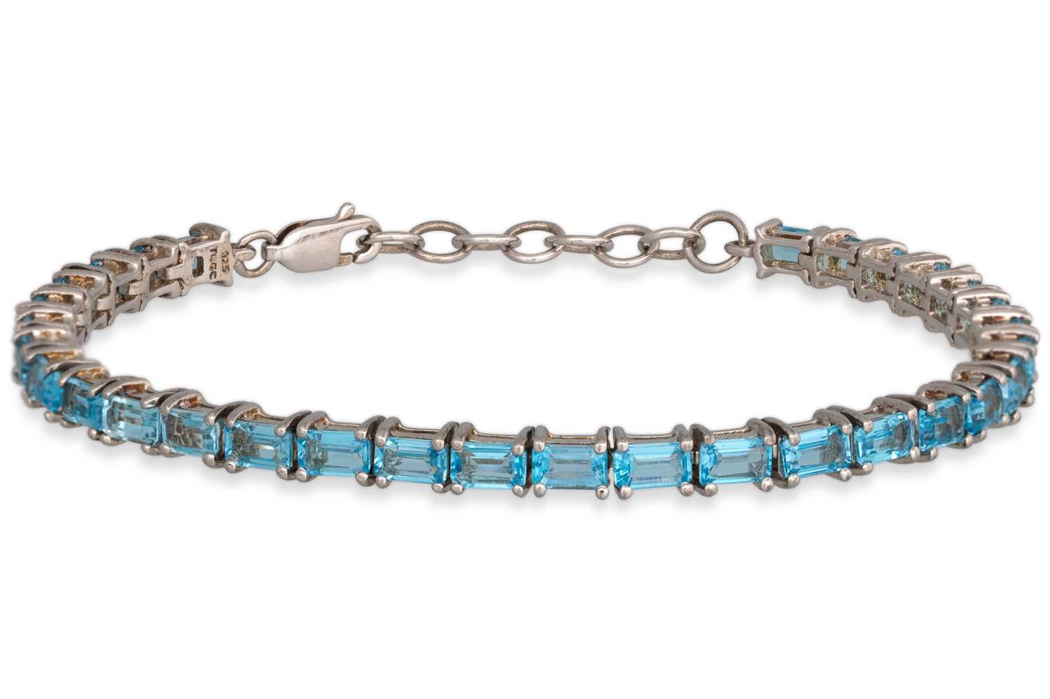 Lot 53 - A TOPAZ TENNIS BRACELET, the rectangular set...