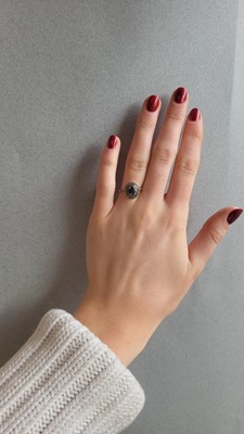 Lot 96 - A SAPPHIRE AND DIAMOND CLUSTER RING, mounted...