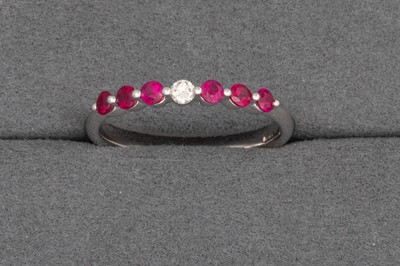 Lot 88 - A RUBY AND DIAMOND SEVEN STONE RING, the...