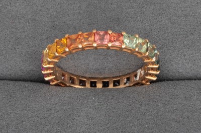 Lot 95 - A RAINBOW SAPPHIRE ETERNITY RING, graduating...