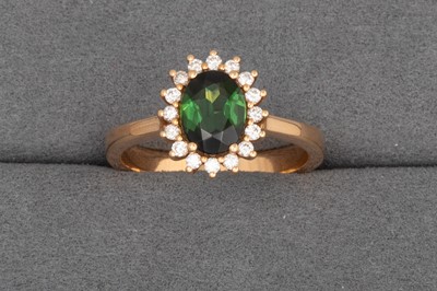 Lot 100 - A GREEN TOURMALINE AND DIAMOND CLUSTER RING,...