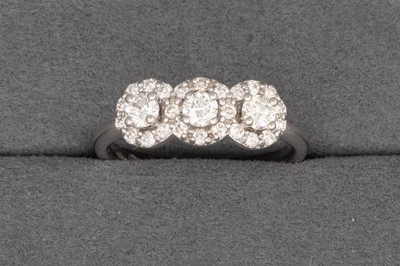 Lot 103 - A DIAMOND TRIPLE CLUSTER RING, the three...