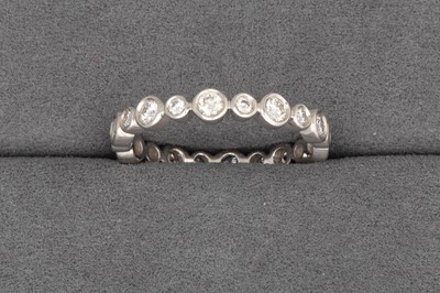 Lot 104 - A FULL BANDED DIAMOND ETERNITY RING, set with...