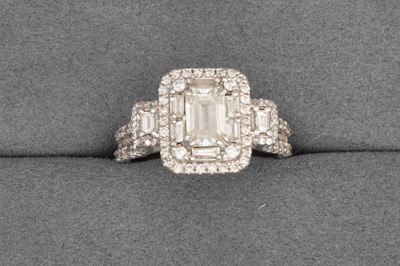 Lot 7 - A DIAMOND CLUSTER RING, set with emerald cut...