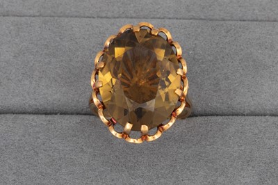 Lot 33 - A 9CT GOLD RING, set with smoky quartz. Size:...