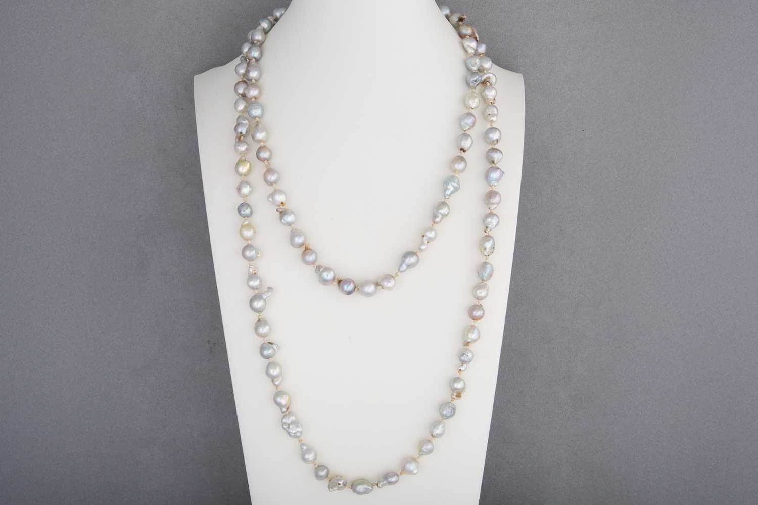 Lot 47 - A STRING OF GREY RIVER PEARLS, to a 14ct gold...