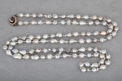 Lot 47 - A STRING OF GREY RIVER PEARLS, to a 14ct gold...