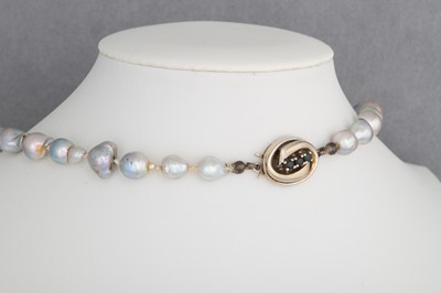 Lot 47 - A STRING OF GREY RIVER PEARLS, to a 14ct gold...