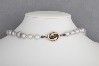Lot 47 - A STRING OF GREY RIVER PEARLS, to a 14ct gold...