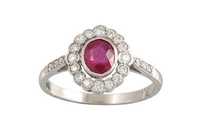 Lot 333 - A RUBY AND DIAMOND CLUSTER RING, the oval ruby...