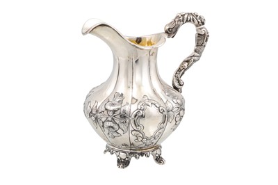 Lot 538 - A VICTORIAN CREAM JUG, chased and engraved...