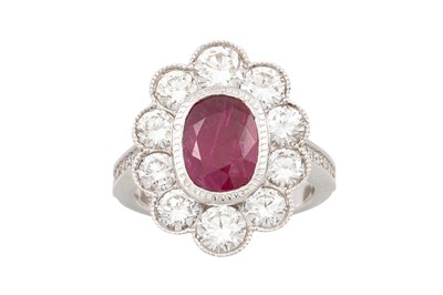 Lot 251 - A RUBY AND DIAMOND CLUSTER RING, of oval form,...