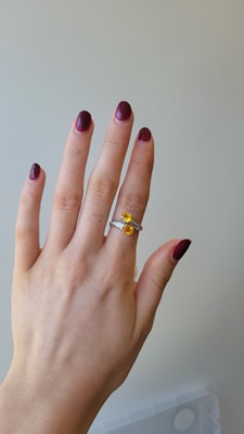 Lot 184 - A YELLOW SAPPHIRE AND DIAMOND CROSS-OVER RING,...