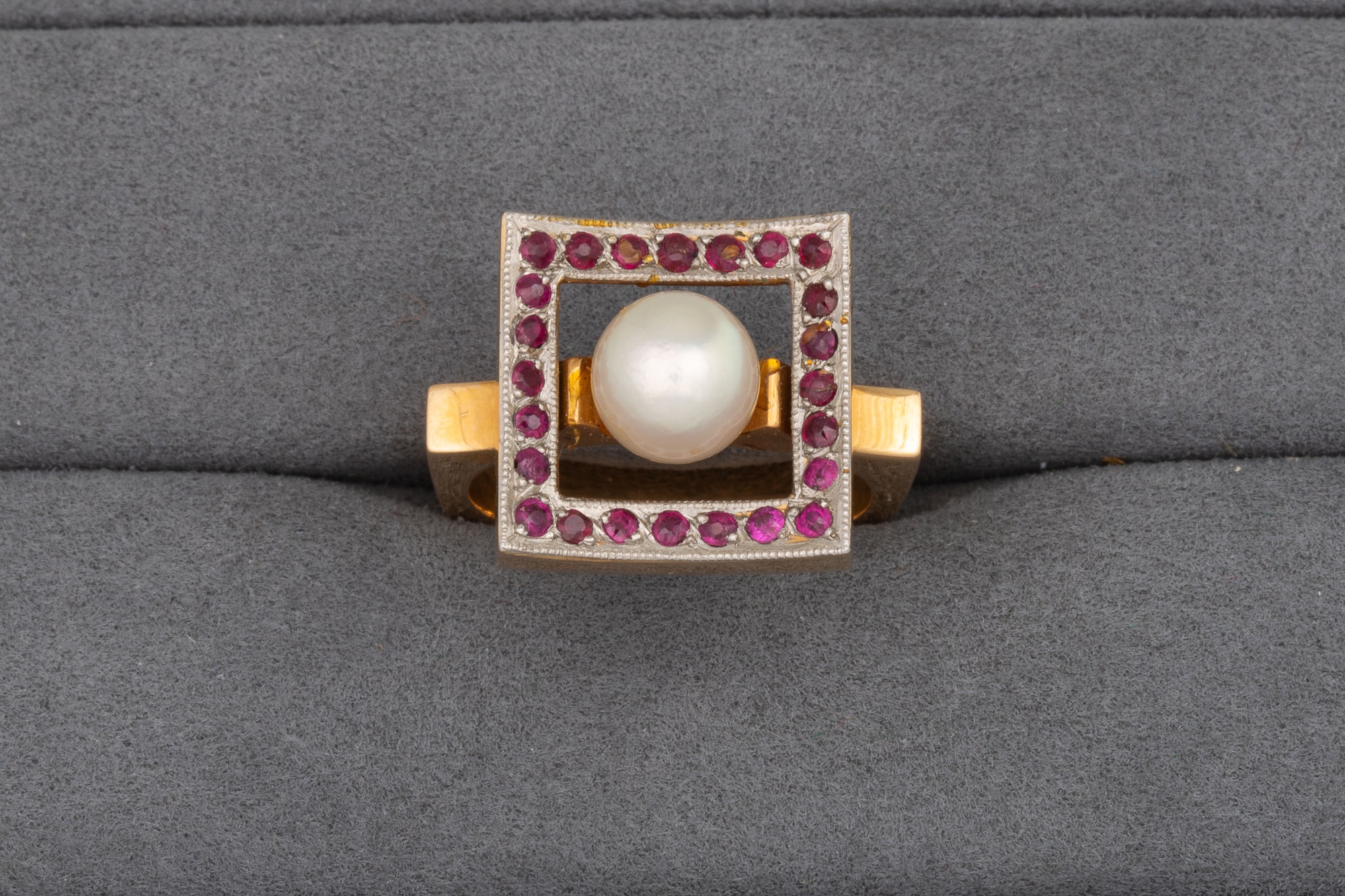 Lot 128 - A VINTAGE RUBY AND PEARL RING, shaped