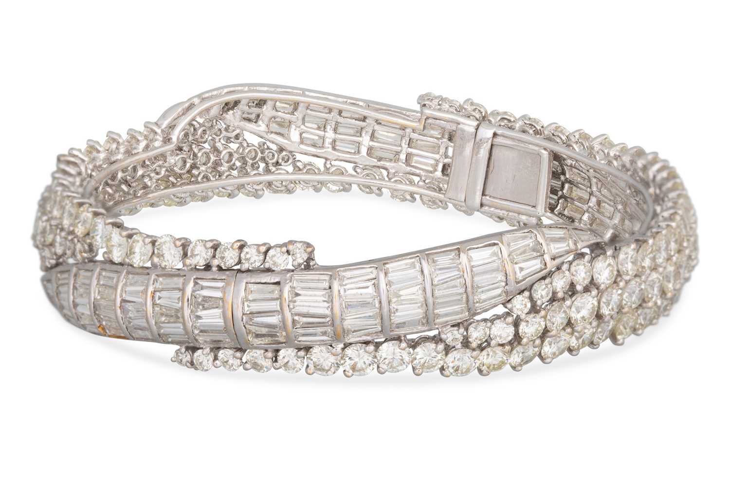 Lot 223 - A DIAMOND HINGED BRACELET, set with brilliant...