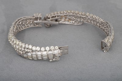 Lot 223 - A DIAMOND HINGED BRACELET, set with brilliant...