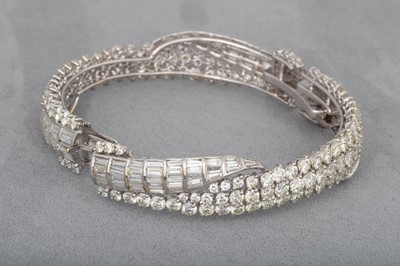 Lot 223 - A DIAMOND HINGED BRACELET, set with brilliant...