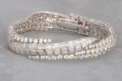 Lot 223 - A DIAMOND HINGED BRACELET, set with brilliant...