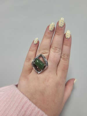 Lot 169 - AN UNUSUAL DESIGN 1970'S GREEN GEM STONE RING,...